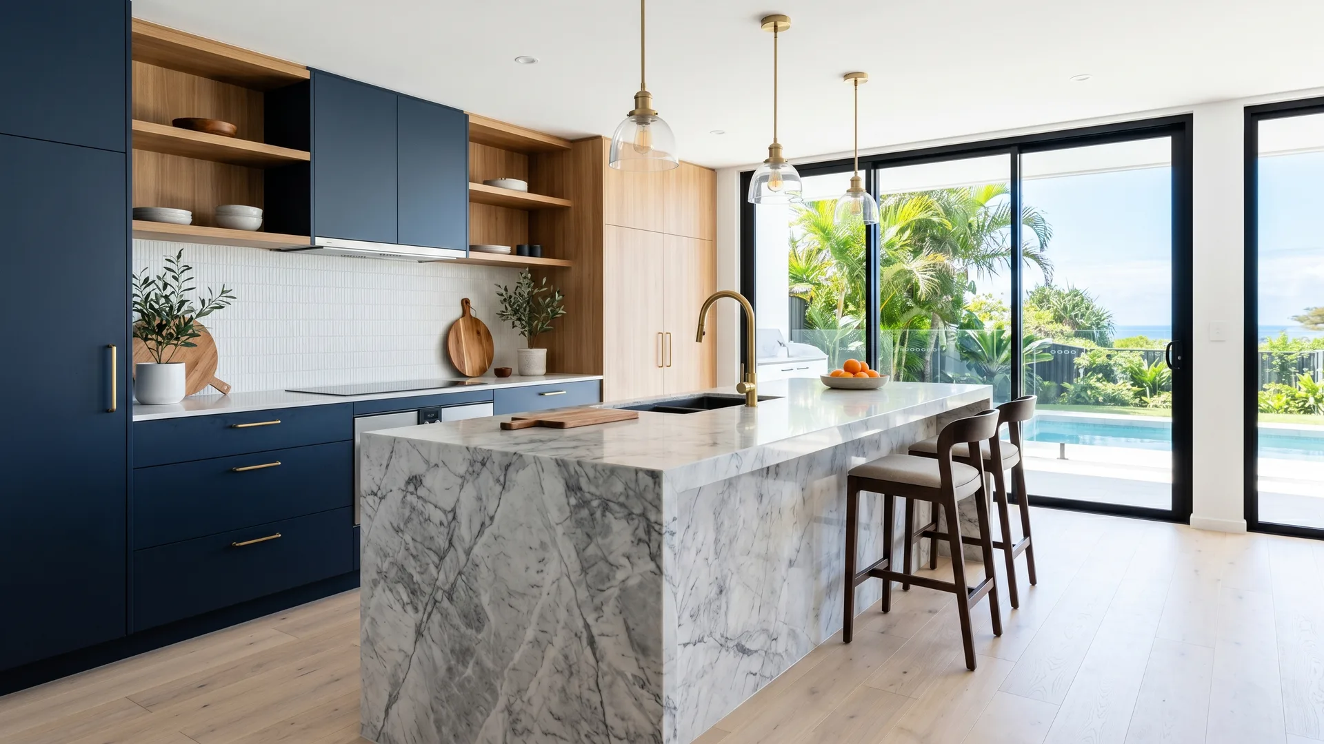 Renovated Gold Coast kitchen with a stone island bench, warm timber cabinetry and pendant lighting